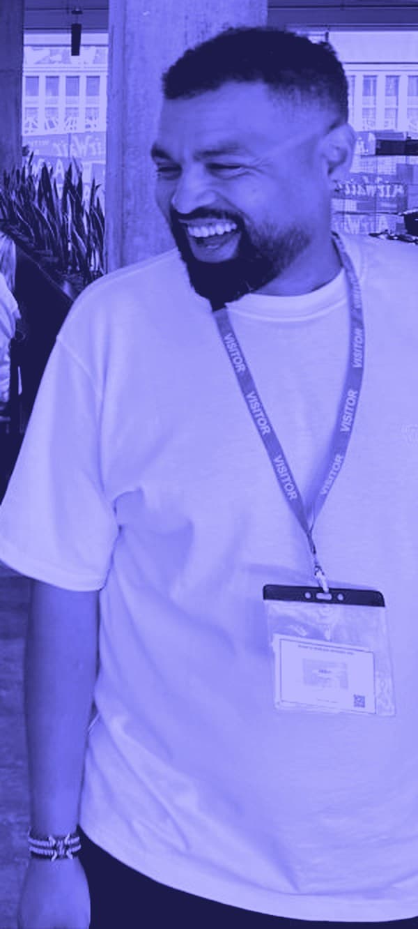 Tom Kegode laughing at an event